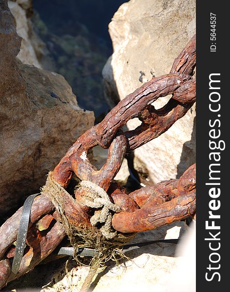 old chains for mooring boats on the rocks