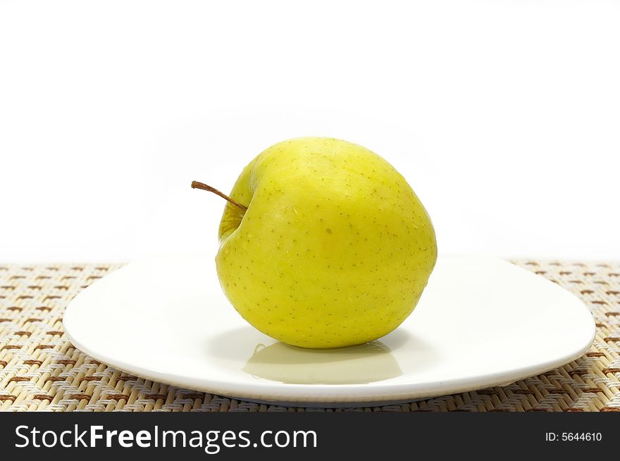 Freshness apple on the white plate isolated. Freshness apple on the white plate isolated
