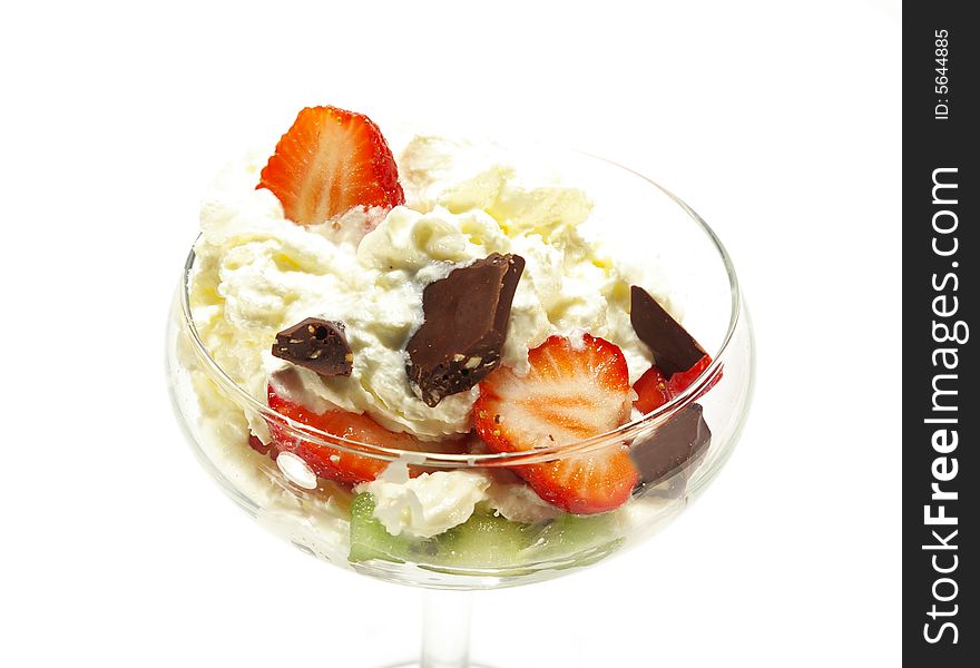 Ice cream topped with syrup, nuts, whipped cream and strawberrie. Image isolated on white. Ice cream topped with syrup, nuts, whipped cream and strawberrie. Image isolated on white.