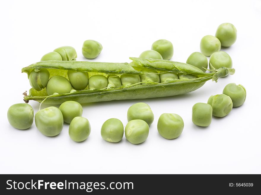 Fresh green peas on a white background