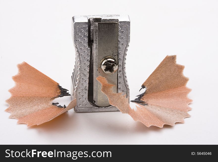 A sharpener and chips on white background