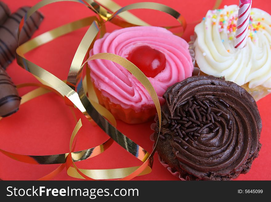 Birthday Cupcake with one candle and gold ribbon