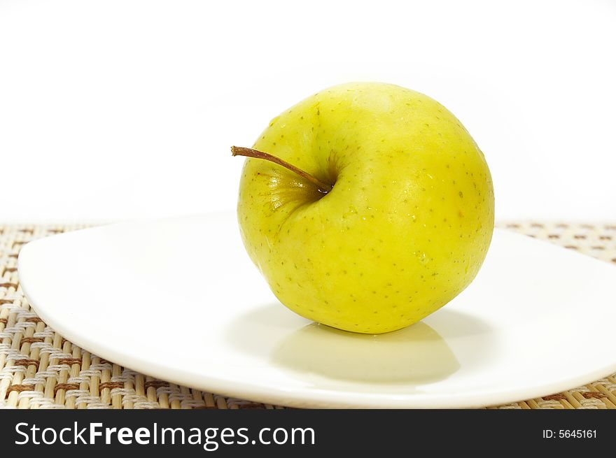 Freshness apple on the white plate isolated