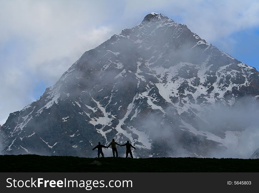 Hikers on the cliff in mountain, Backpackers silhouette