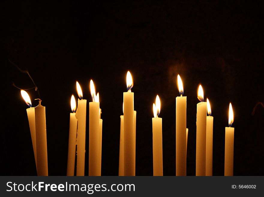 Composition of Candles with flames moved by the wind