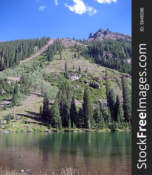 Lake in front of a steep mountain. Lake in front of a steep mountain.