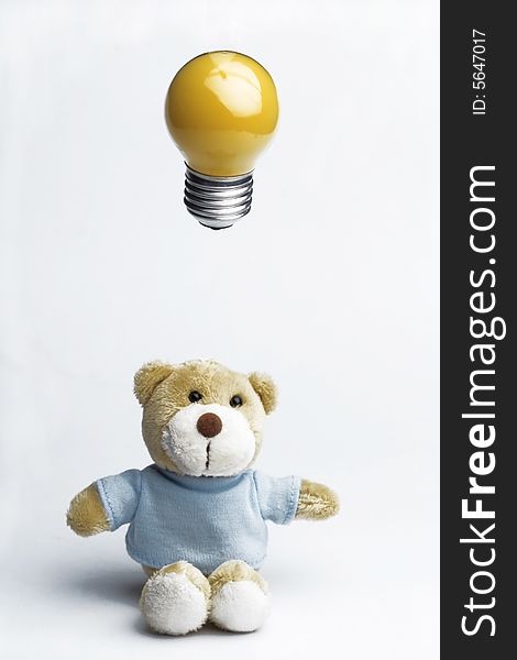New idea concept - teddy bear and light bulb