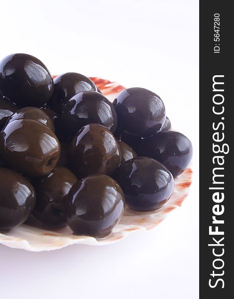 Close up of black olives in white background