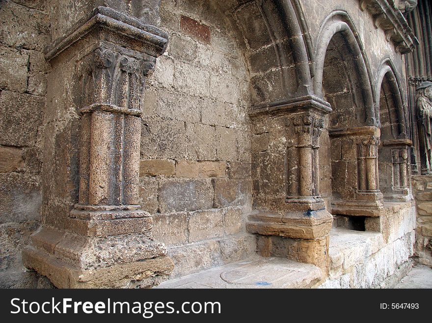 Ancient columns with arches on a facade of a church in Estella, Navarra, Spain