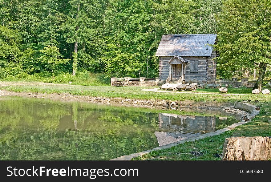 An old weathered mill on a pond. An old weathered mill on a pond