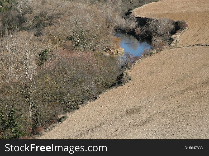 Fields and forest along a river in Foz de Lumbier, Navarra, Spain
