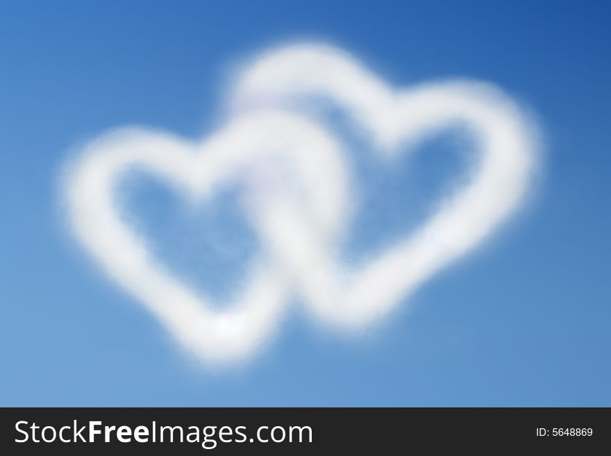 Two heart-shaped clouds in the clear blue sky