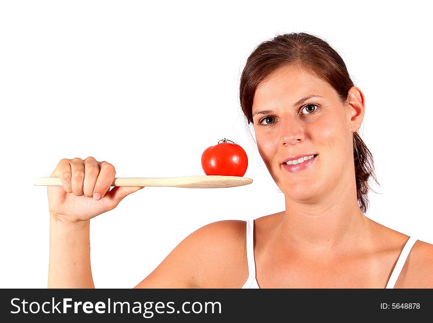 A young happy woman with a tomato and a spoon. Can be used as a cooking / diet shot. A young happy woman with a tomato and a spoon. Can be used as a cooking / diet shot.