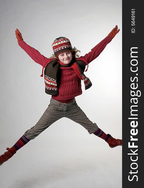 A girl jumping up with her hands in the air