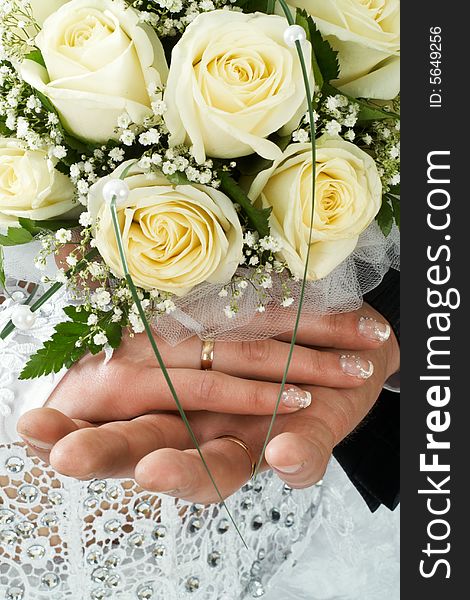 Wedding bouquet of roses holding by bride and groom. Wedding bouquet of roses holding by bride and groom