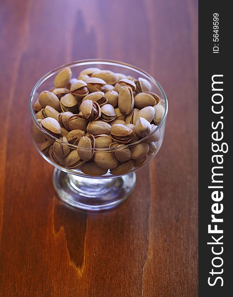 Bowl with pistachios on a table