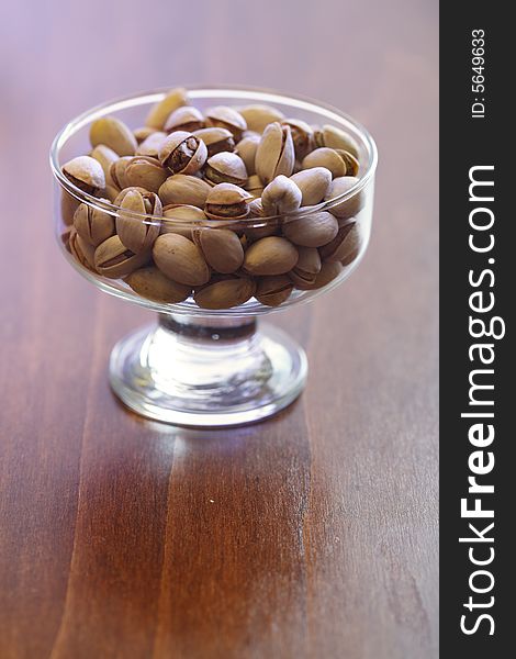 Bowl with pistachios on a table