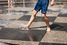 Feet Of Boy Playing In The Fountain Stock Photos