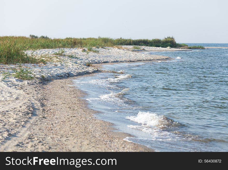 Sandy foreland at seaside at warm summer morning. Sandy foreland at seaside at warm summer morning