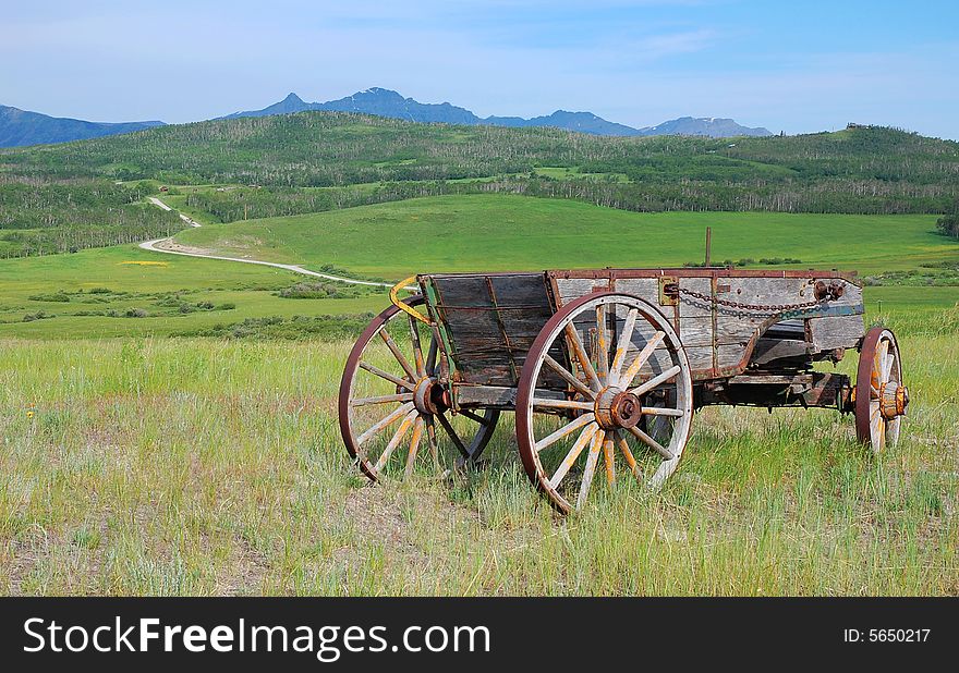 An antique farming tool standing in southern alberta prairie, canada. An antique farming tool standing in southern alberta prairie, canada