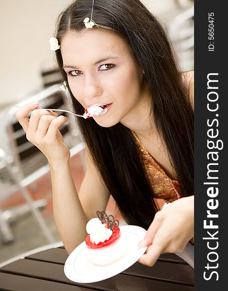 Girl eating a cake in cafe. Girl eating a cake in cafe