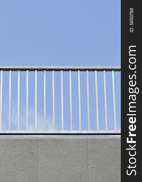 A railing against a blue sky. A railing against a blue sky