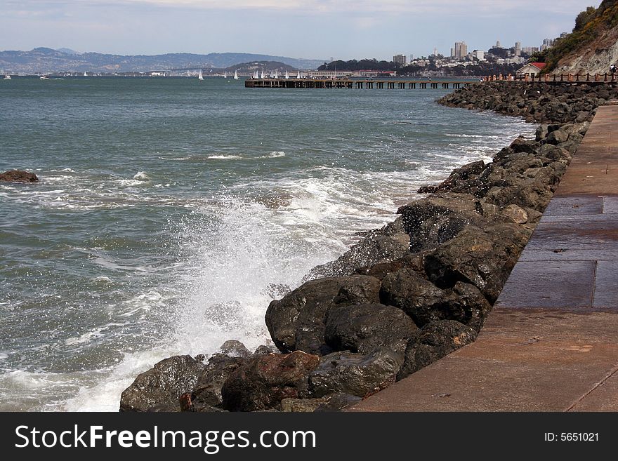 Waves splashing upon rocks near the historic Fort Point in San Francisco, California