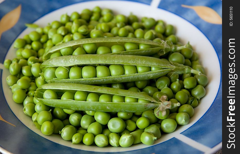 Green pea pods on bed of peas. Green pea pods on bed of peas