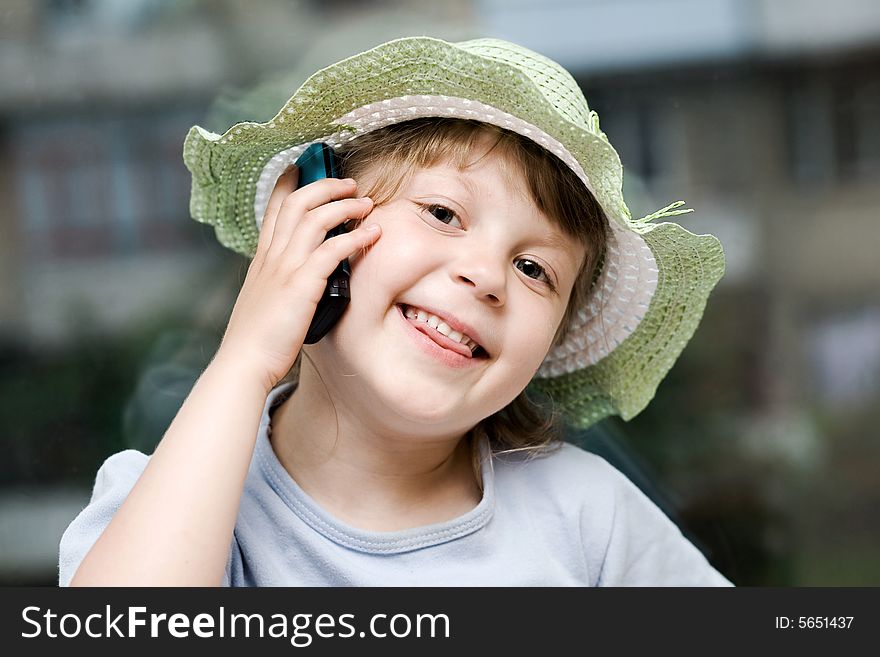 An image of young girl speaking on the phone. An image of young girl speaking on the phone