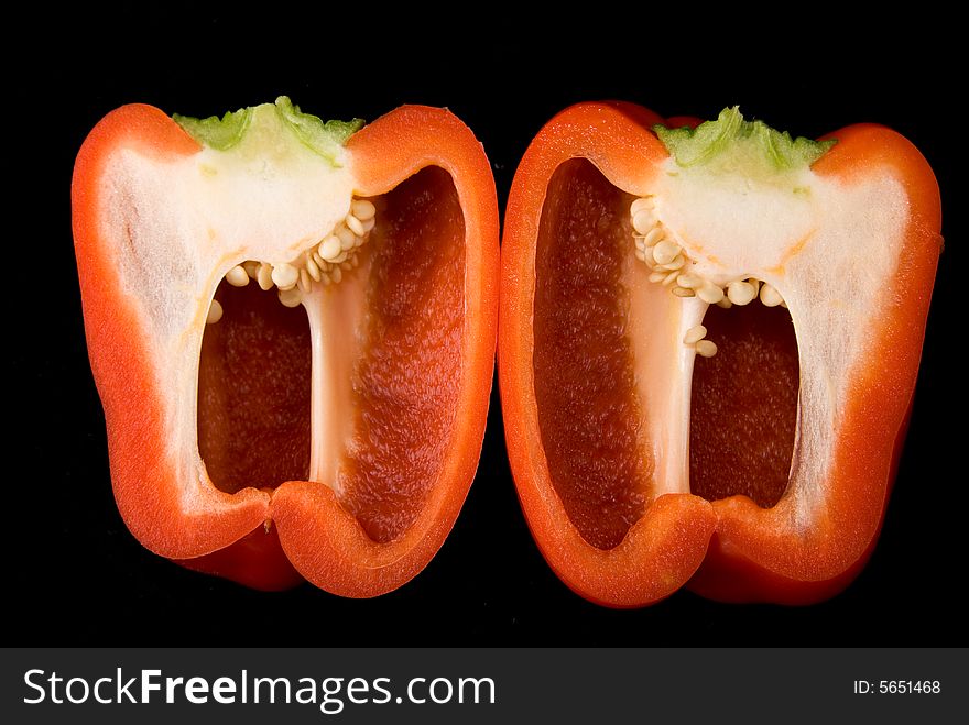 Beautiful dissected pimiento on black background, studio style. Beautiful dissected pimiento on black background, studio style