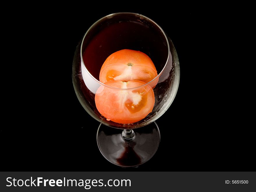 Fresh dissected tomato in bright glass goblet. Fresh dissected tomato in bright glass goblet