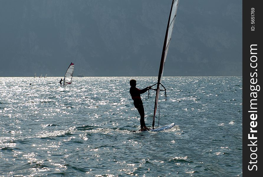 Surf on silver garda lake, silouette. Surf on silver garda lake, silouette