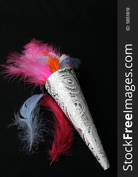 Brightly colored feather confetti in a cone