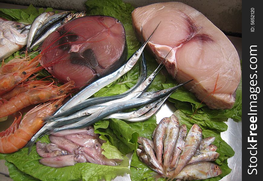 Sea food, fish, slices of fish, Mediterranean cuisine, Sicilian cuisine, fresh fish, shrimps,squids