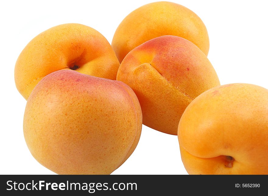 Five apricots isolated over white