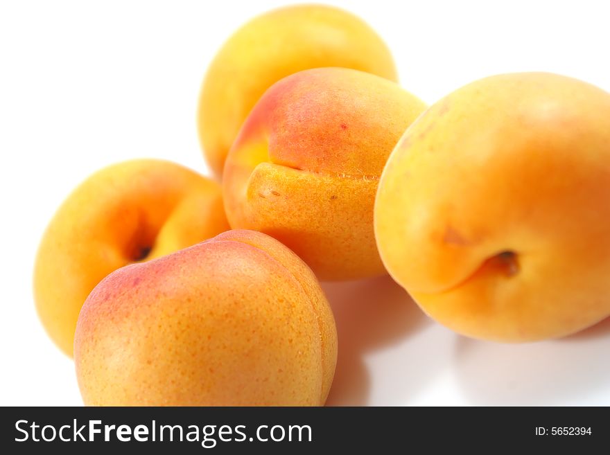 Five apricots isolated over white