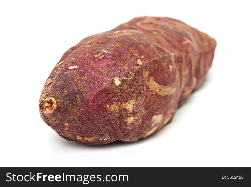 A purple sweet potato isolated on white background.