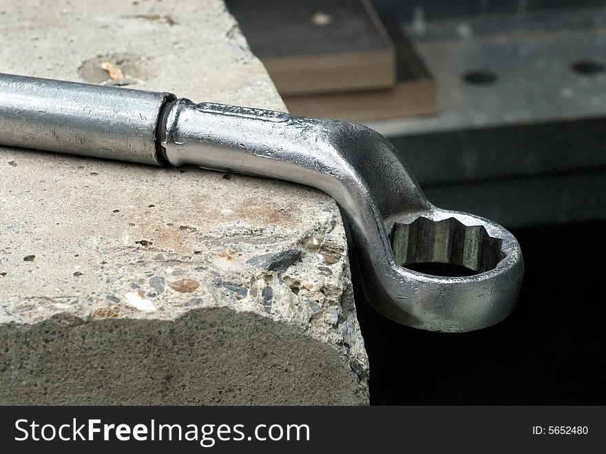 Big wrench on pice of concrete