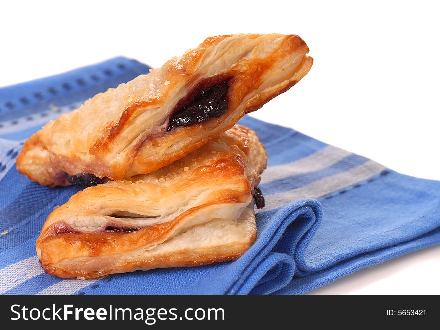 Freshly baked blueberry turnovers resting on a napkin. Freshly baked blueberry turnovers resting on a napkin