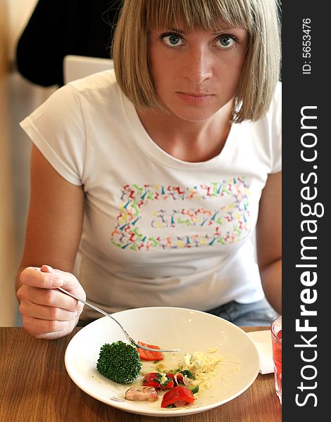 Beautiful young woman eating vegetables. Beautiful young woman eating vegetables