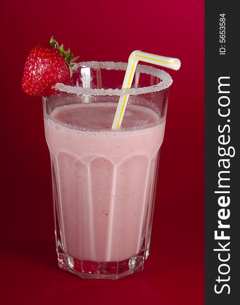 Pink milkshake, with strawberry and straw. Pink milkshake, with strawberry and straw