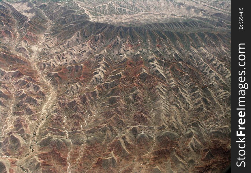 Take the photo from airplane near Urumqi. the mountain is part of Ttianshan mountains in SinKiang, China.
