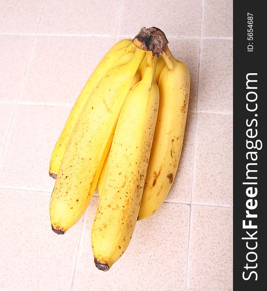 A banana on a kitchen counter top. A banana on a kitchen counter top