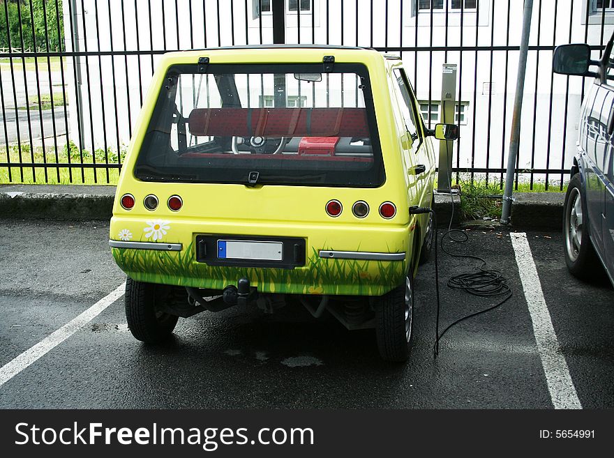 Ecology car - electromobile charging on the parking