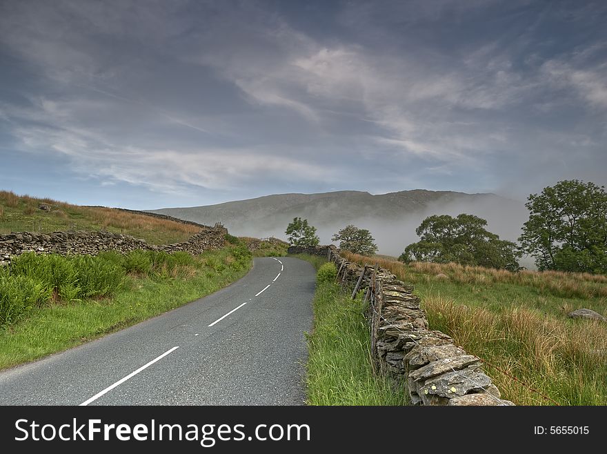 The Kirkstone Pass road in the English Lake District, A bank of fog can be seen in the distance