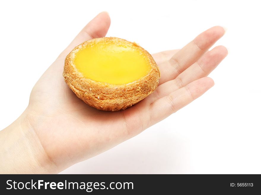 An egg tart holding on a lady hand. An egg tart holding on a lady hand.