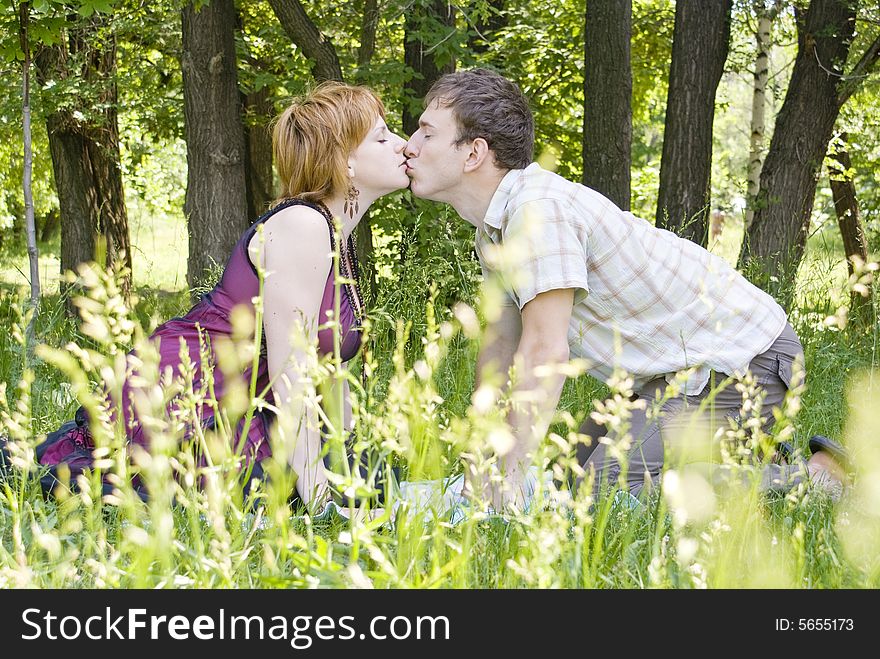 Man and woman kissing in the park