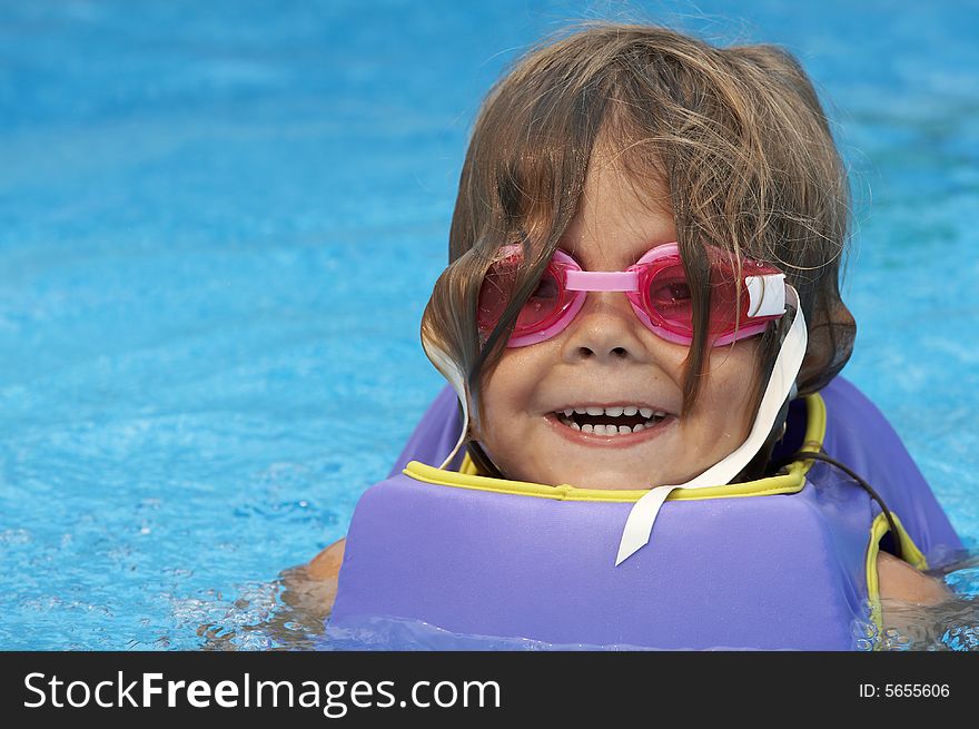 A young girl playing in pool. A young girl playing in pool