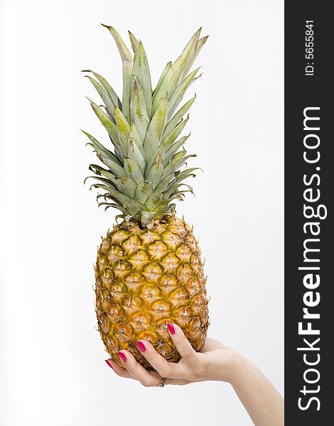 Big pineapple in a woman hand