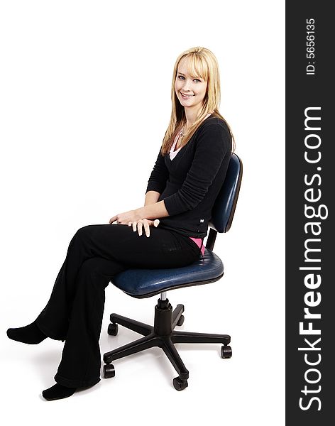 Beautiful blonde businesswoman sitting on a blue seretary's chair. Isolated on white background. Beautiful blonde businesswoman sitting on a blue seretary's chair. Isolated on white background